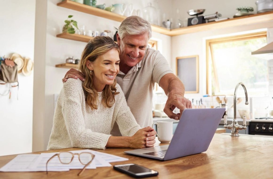 A couple working through the course together at a kitchen laptop